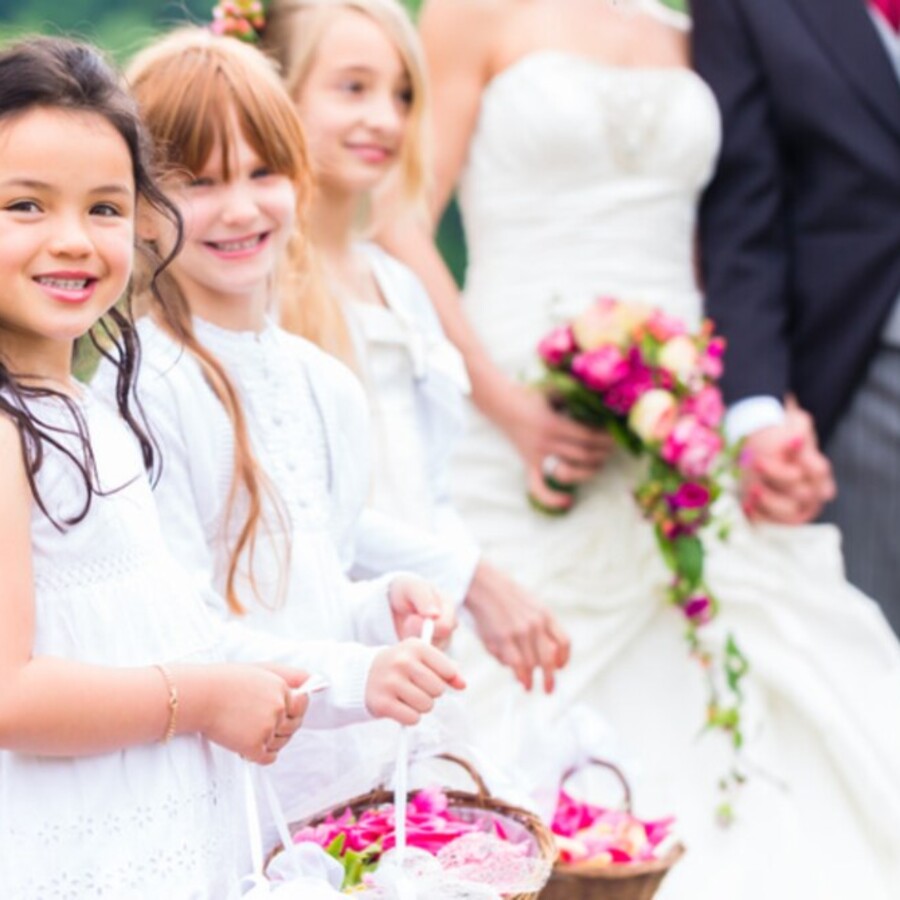 Flower girls walking together at a wedding