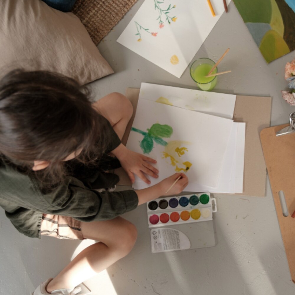 A child painting during a Crafty Beans weekly session