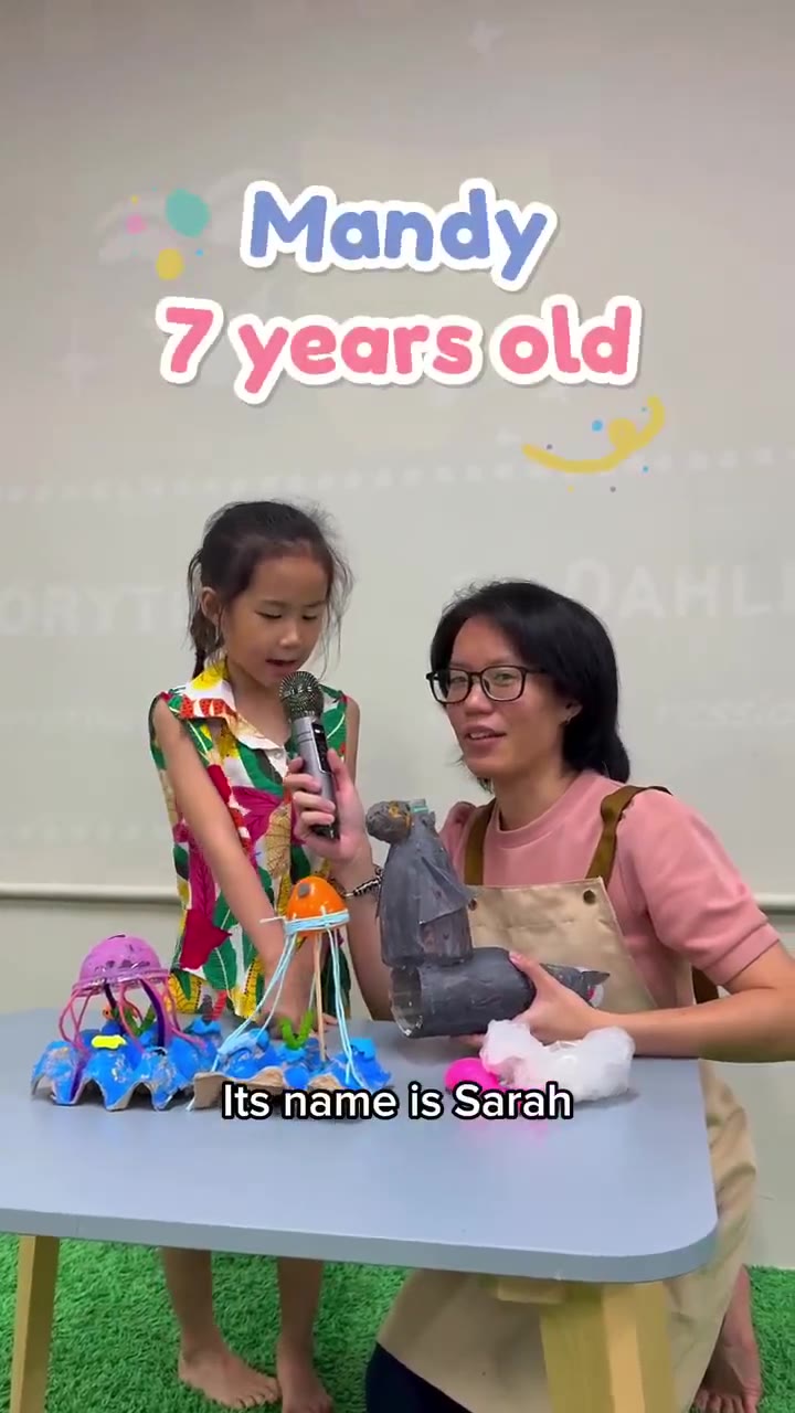 A child presenting her craft artwork