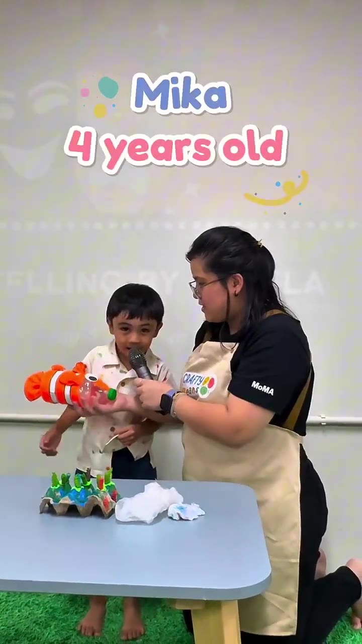 A child presenting her craft cake