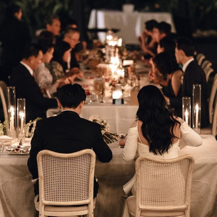 A couple at a candlelit formal wedding dinner reception