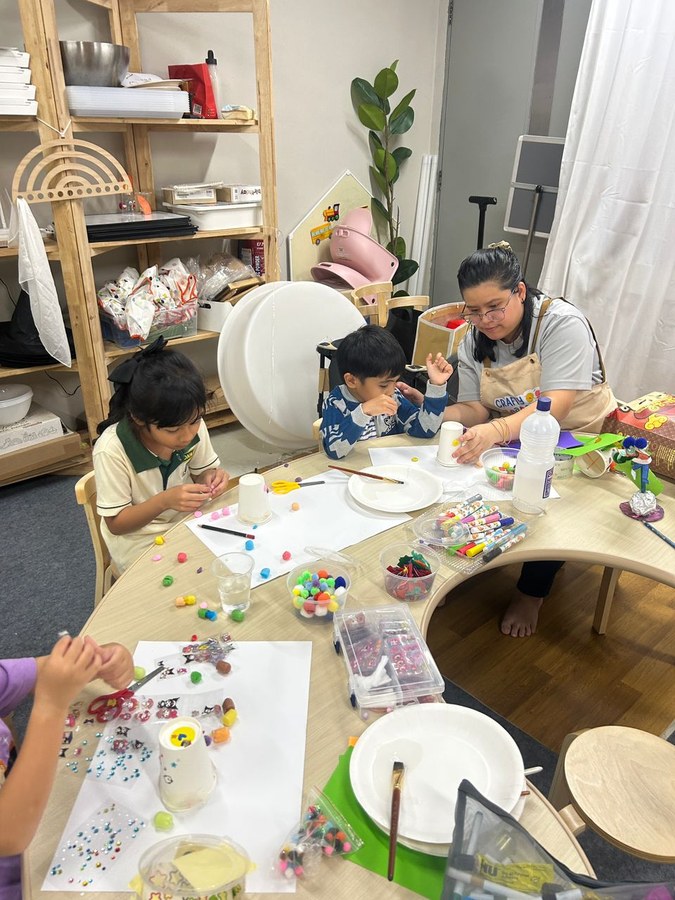 Children crafting at a workshop table